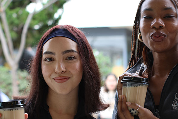 two students holding boba tea